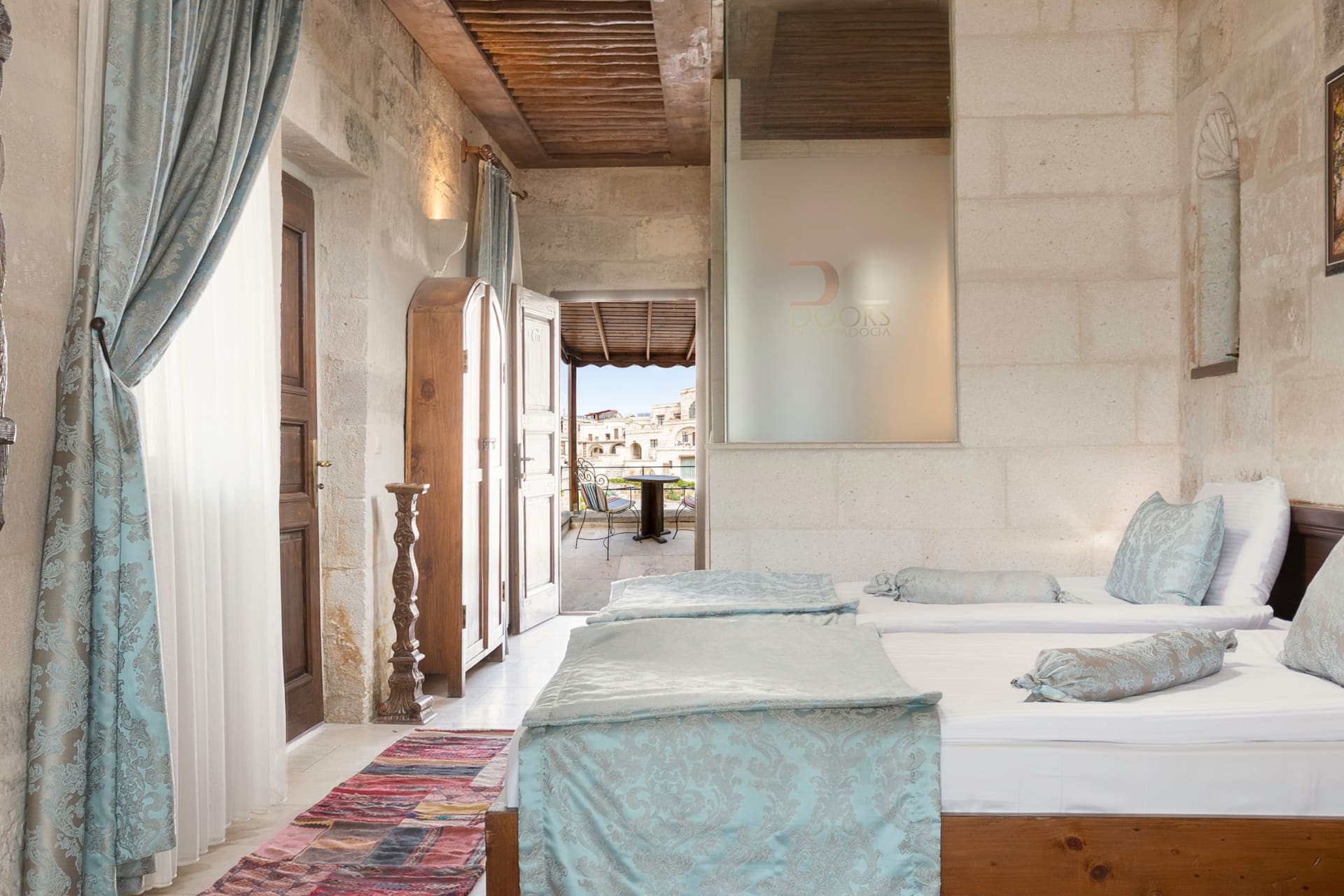 Room 118, Deluxe: Two beds, frosted-glass partition, doors opening to the terrace
