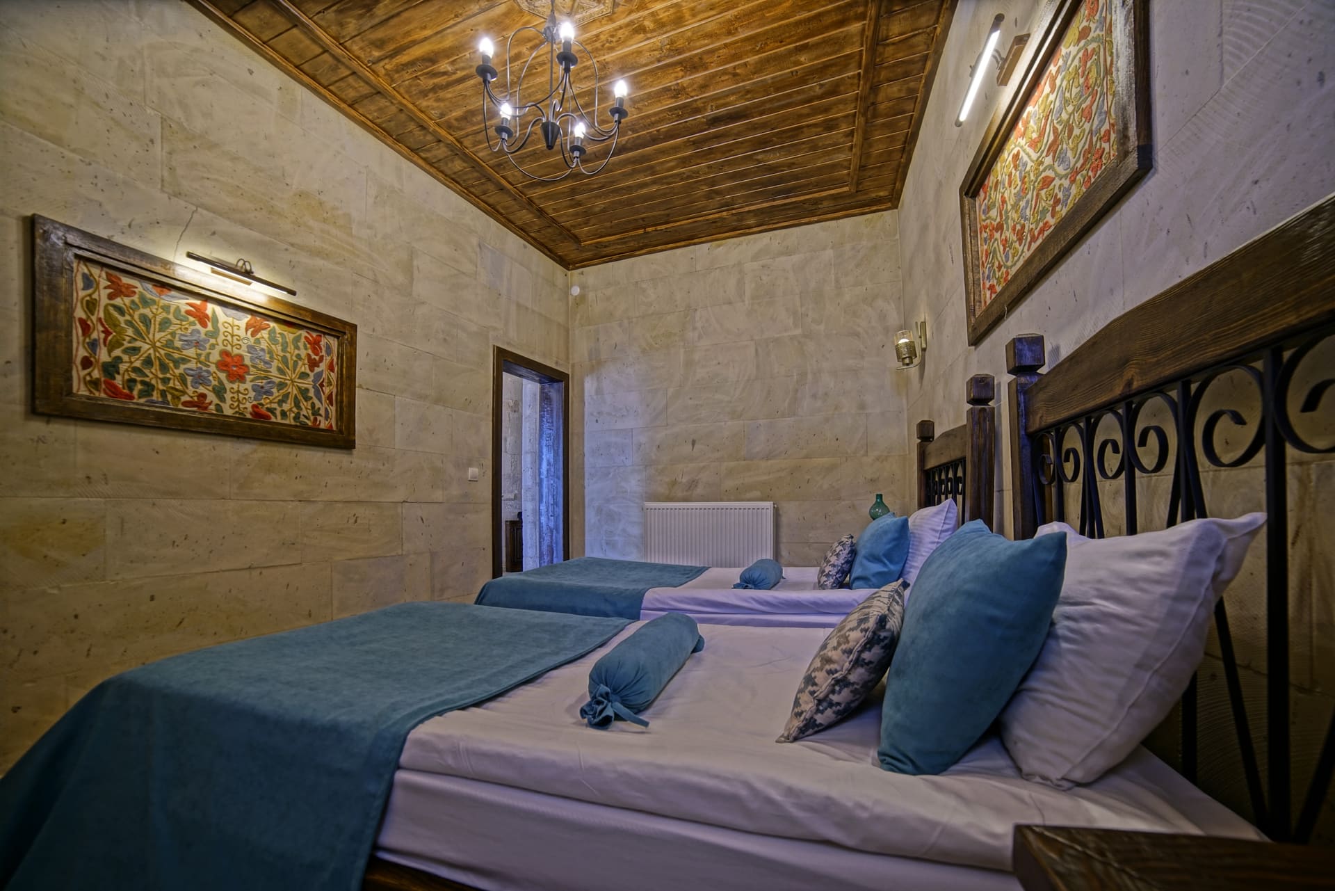 Room 119, Junior Suite: Two single beds, wrought-iron headboard and blue pillows