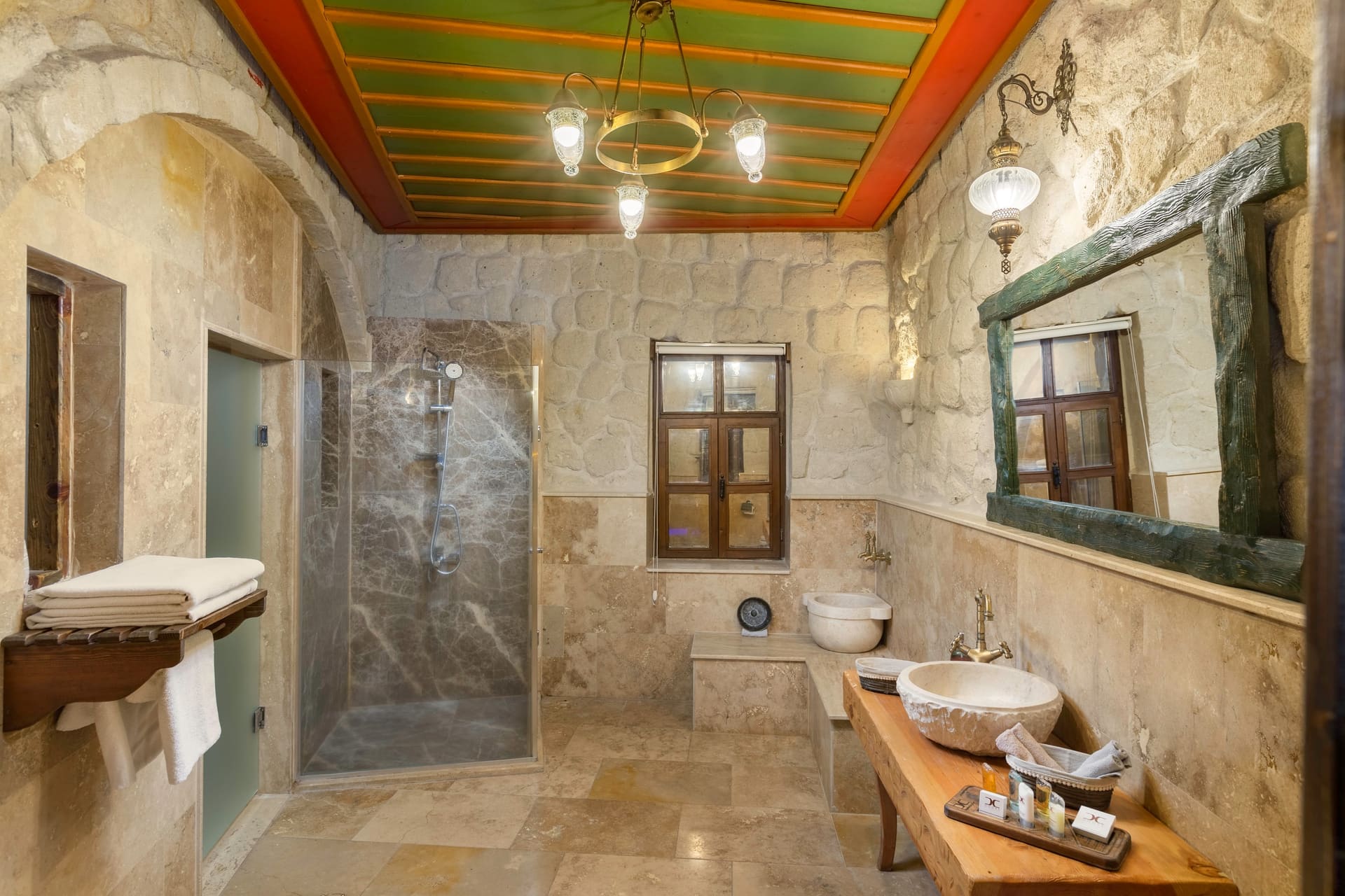 Room 120, Queen Suite: Bathroom with a stone shower, wash basin and pendant lighting.
