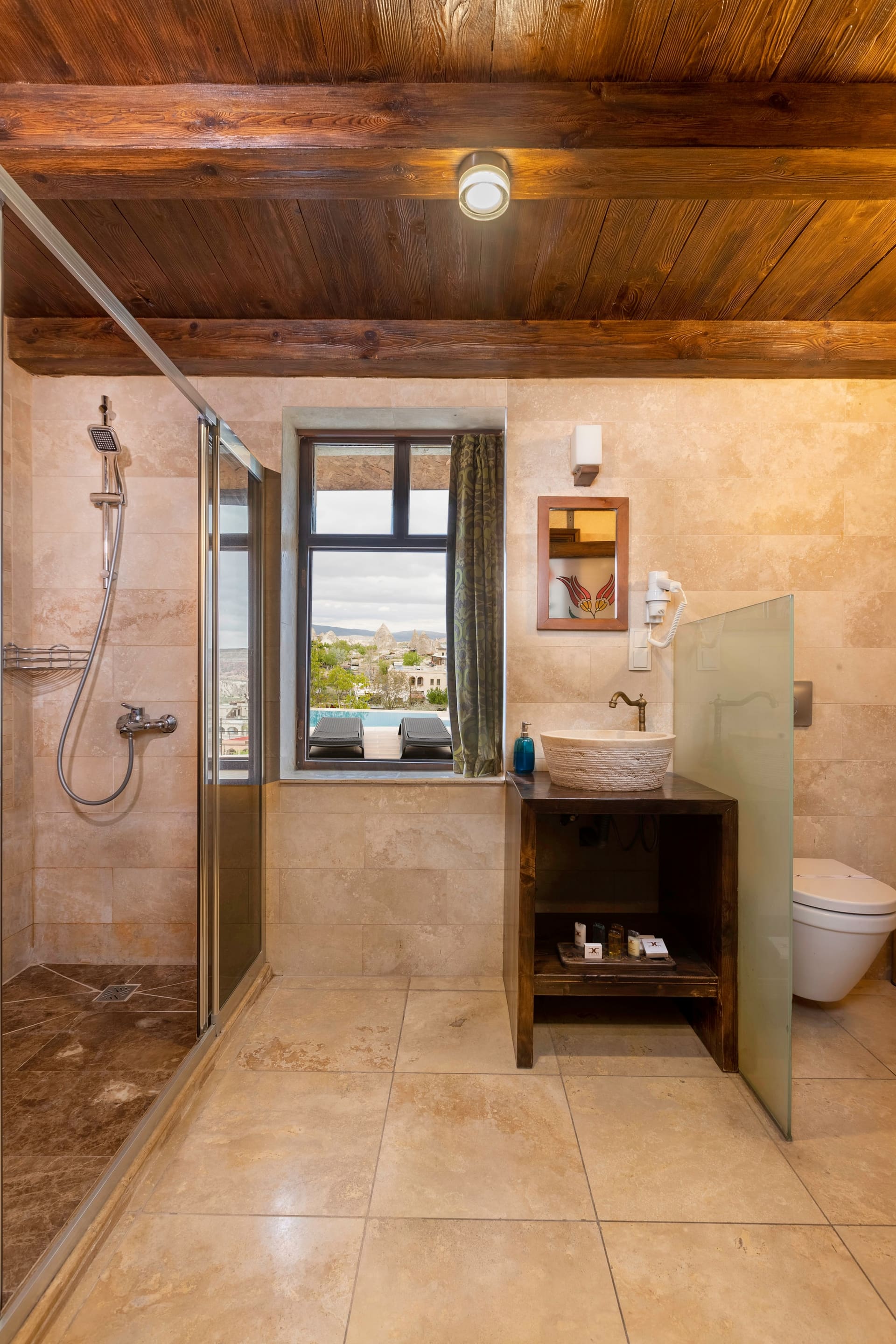 Room 104, Junior Suite: Bathroom, glass shower door, sink, mirror, window view.