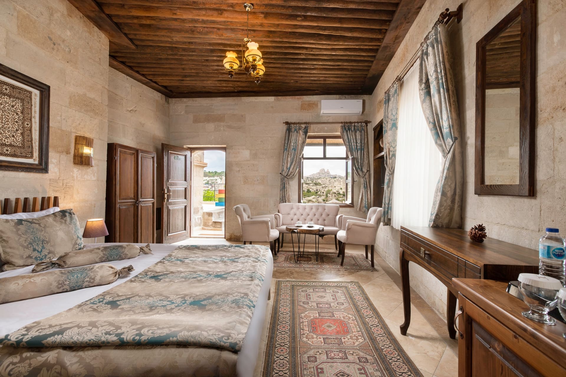 Room 103, Deluxe: View from the bedroom toward the seating area, wooden ceiling, large windows