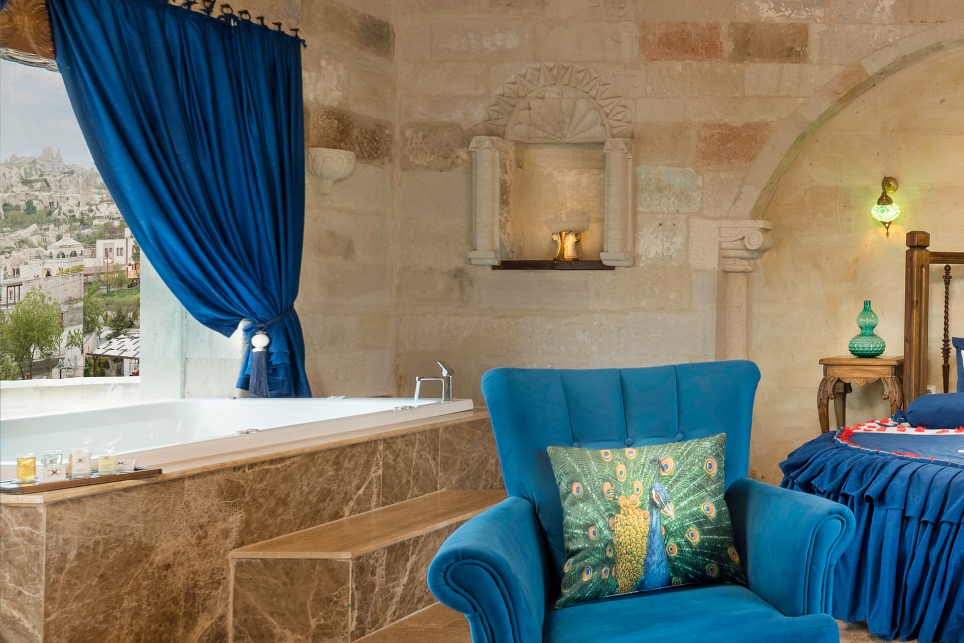 Room 120, Queen Suite: Jacuzzi tub and a blue armchair in front of the arched window.