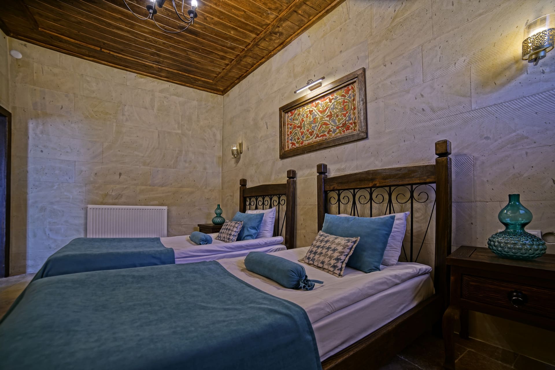 Room 119, Junior Suite: Two single beds, wooden ceiling and a woven wall hanging