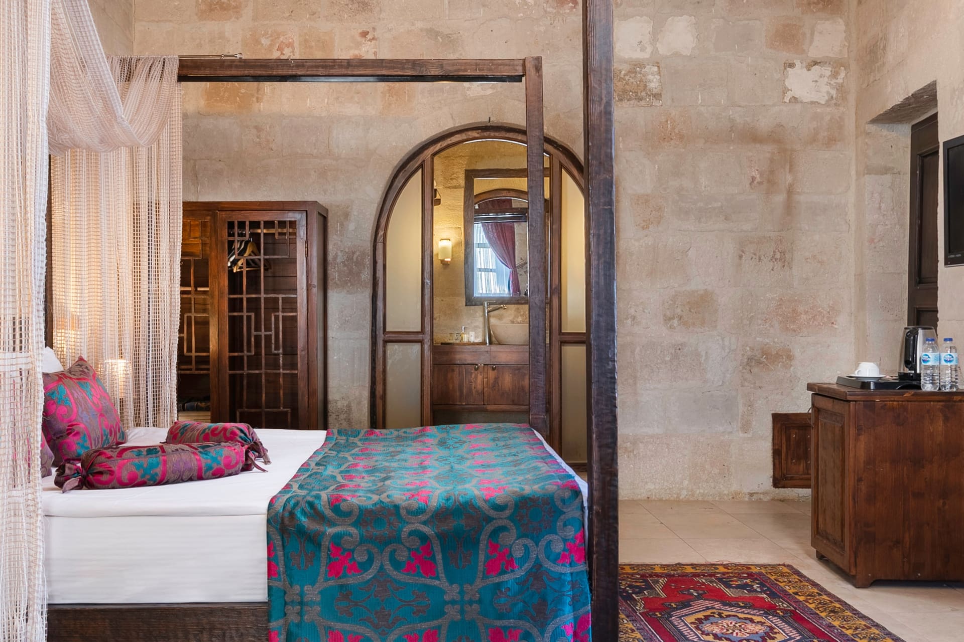 Room 102, Junior Suite: Single bed, arched wooden door, wooden chest of drawers.