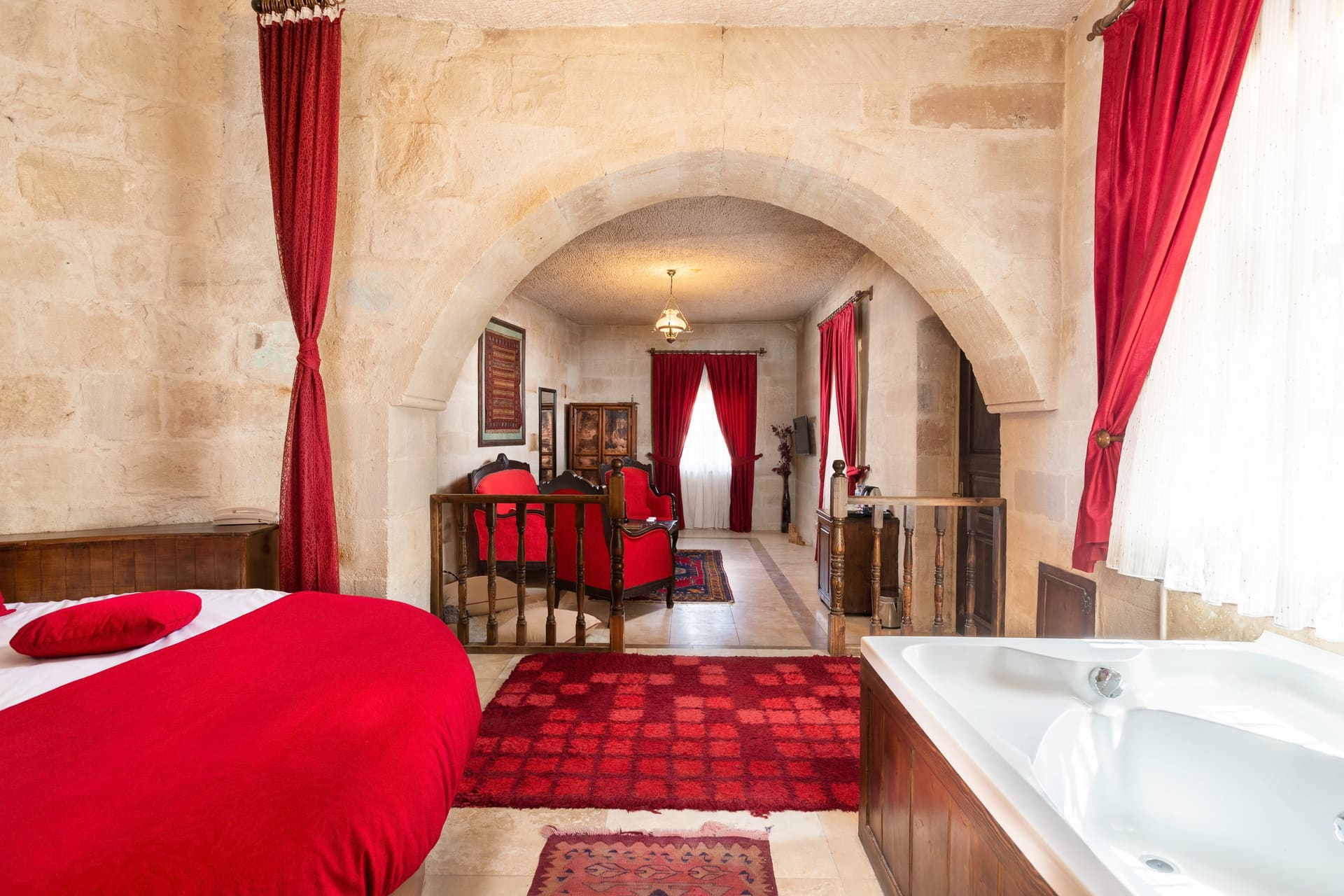 Room 107, King Suite: the red bed with the jacuzzi tub visible alongside it