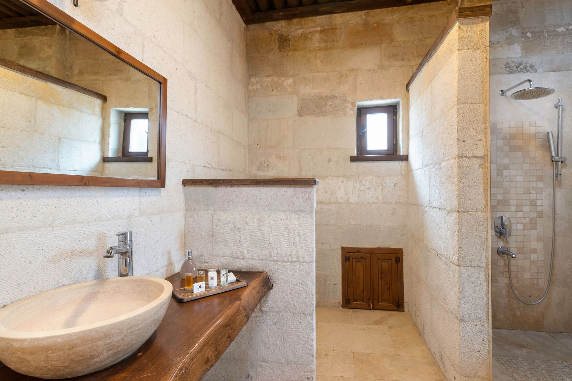 Room 117, Junior Suite: Bathroom, vessel sink, mirror, open shower, stone walls.