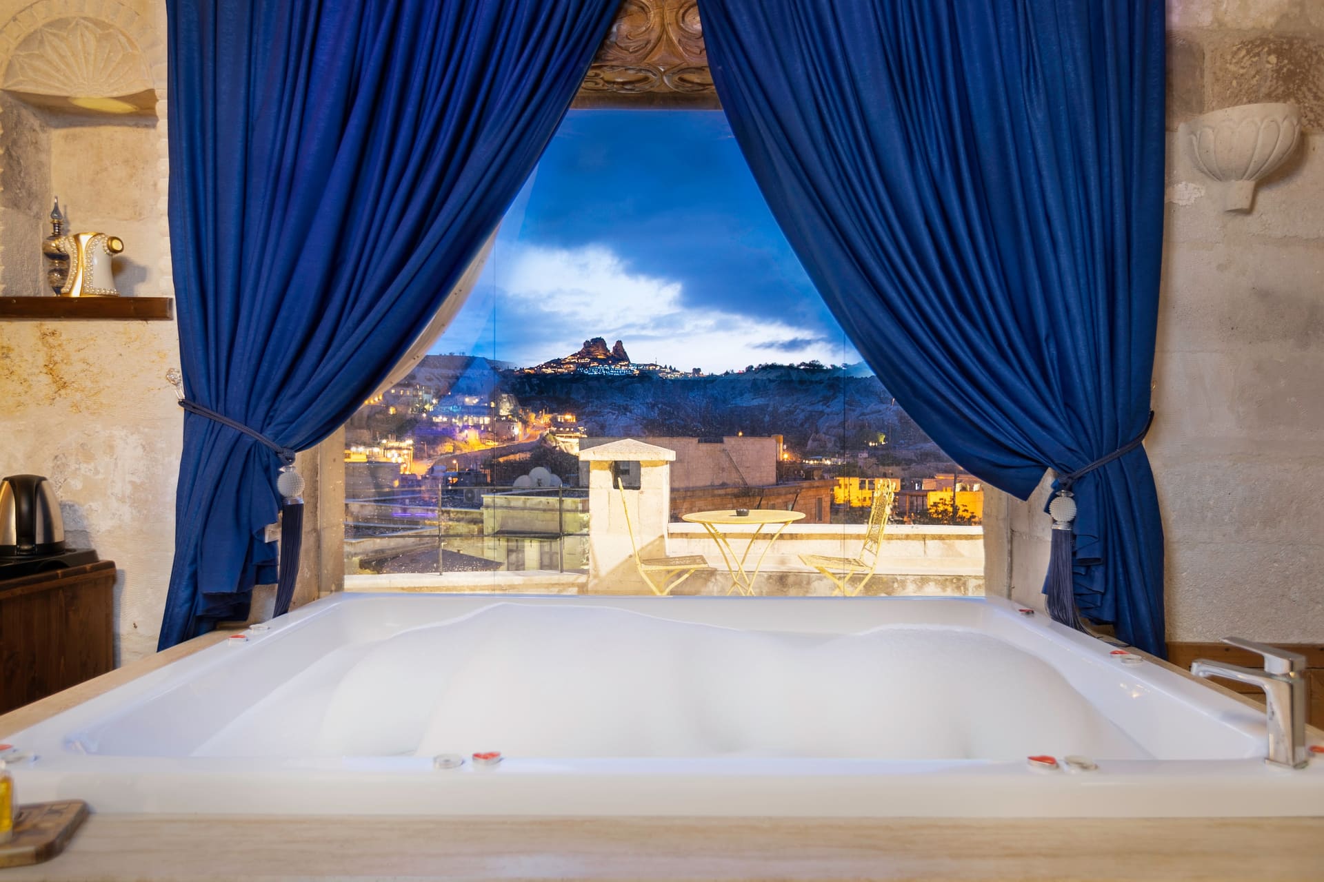 Room 120, Queen Suite: Jacuzzi tub with the arched window framing a night view of the town.