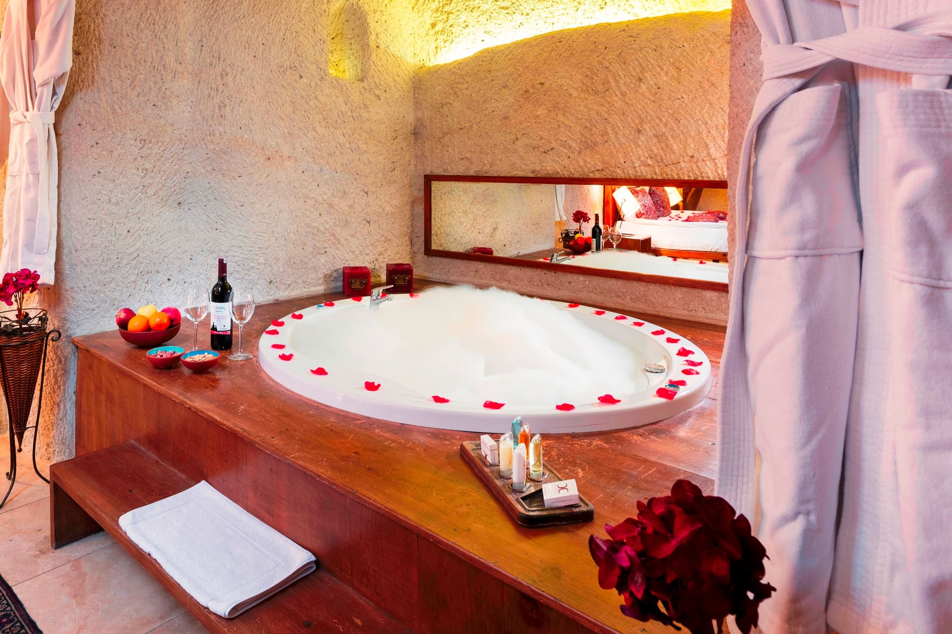Room 111, King Cave Suite: a closer view of the same jacuzzi tub, its rim decorated with rose petals