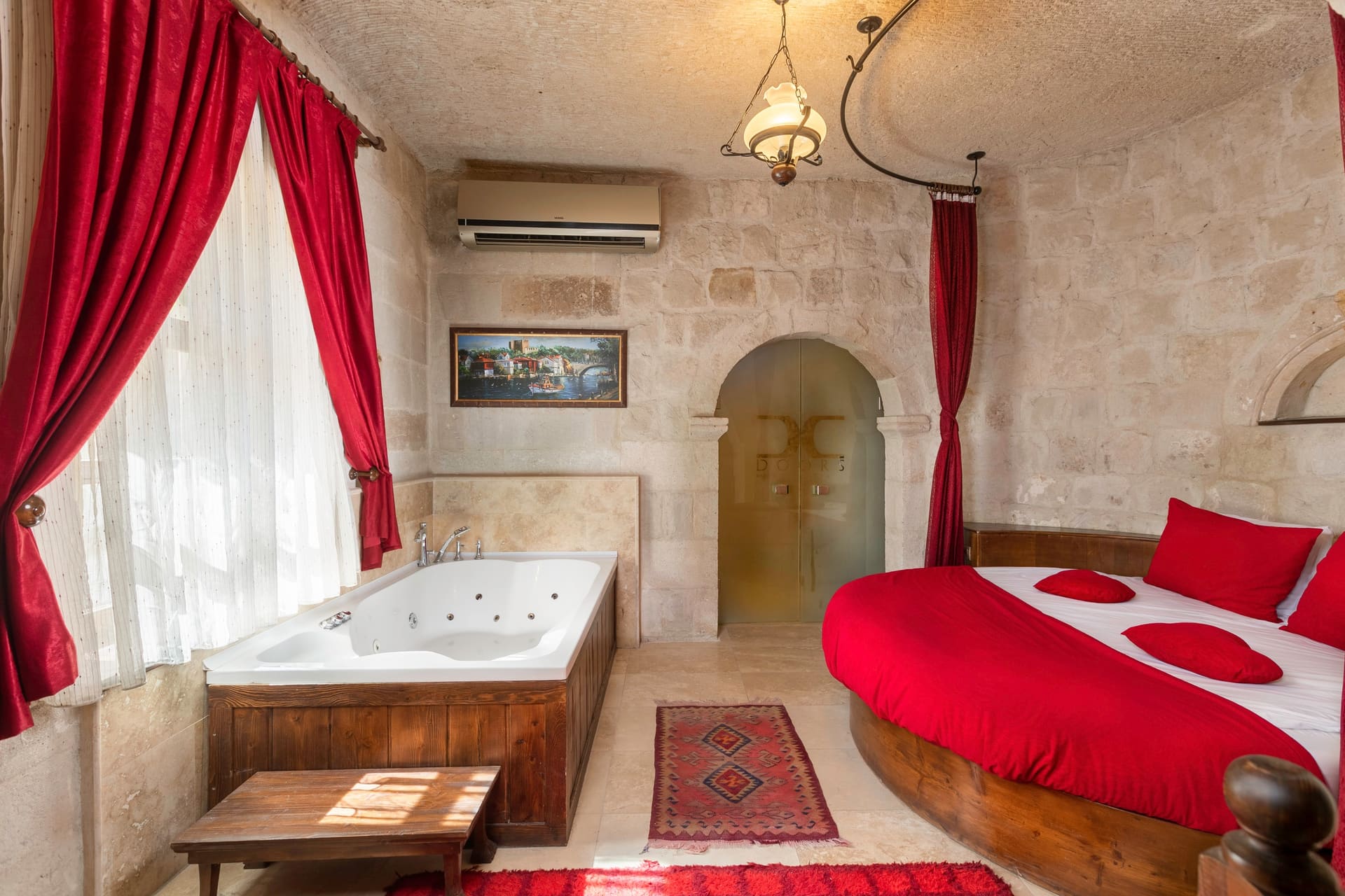 Room 107, King Suite: the jacuzzi tub and the round red bed seen together