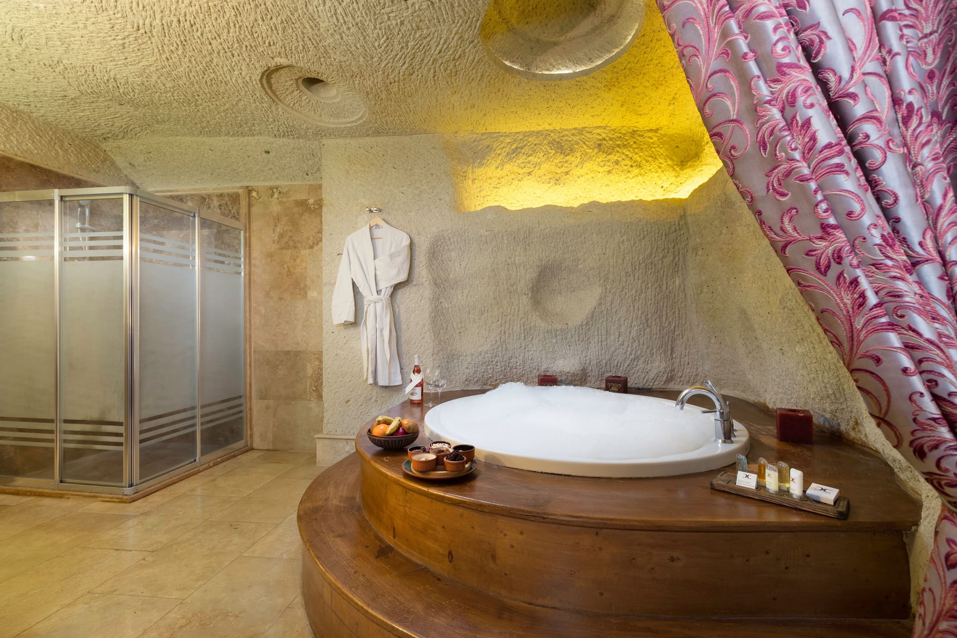 Room 112, King Cave Suite: a wider view of the jacuzzi tub with the glass shower stall visible behind it