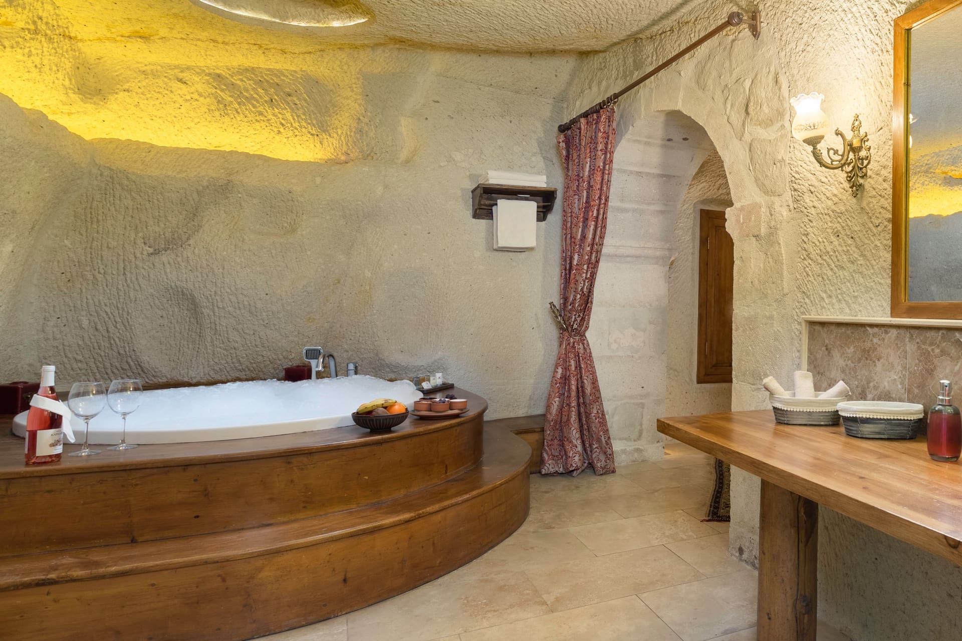 Room 112, King Cave Suite: close-up of the blue vessel sink, a hanging robe reflected in the mirror