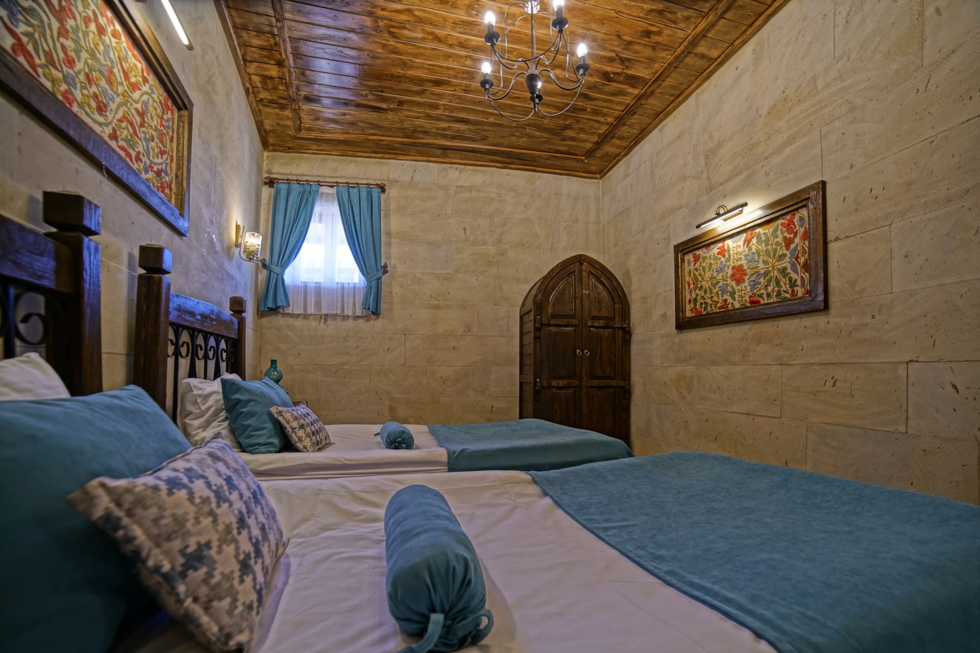 Room 119, Junior Suite: Two single beds, a curtained window and an arched door