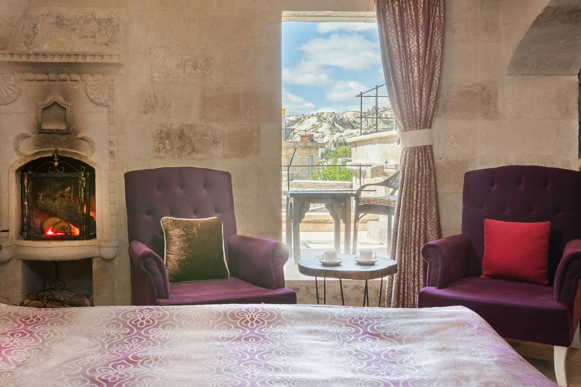 Room 109, Deluxe: Close view of the fireplace, purple armchairs and the window view