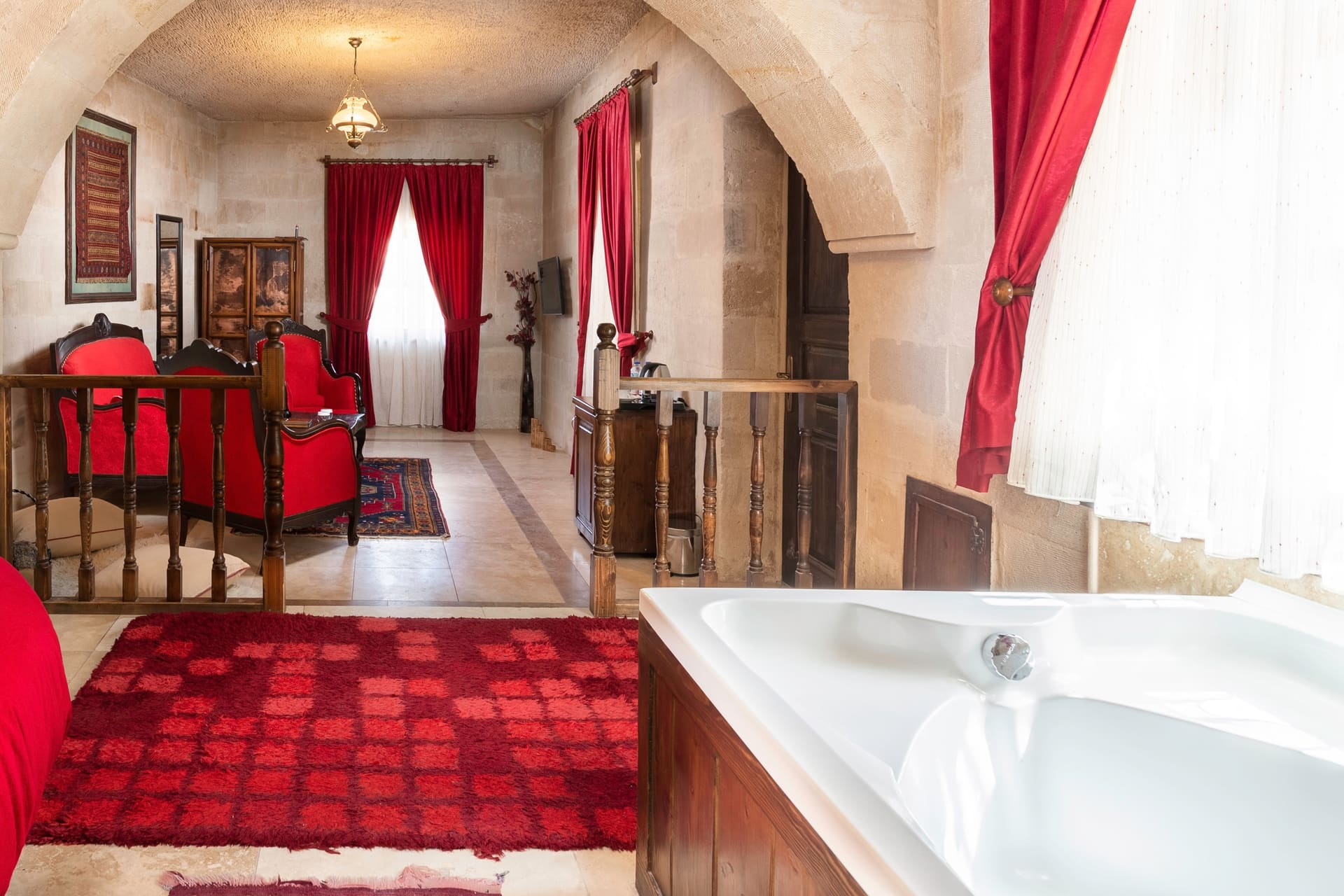 Room 107, King Suite: the raised sleeping nook with the jacuzzi tub below it
