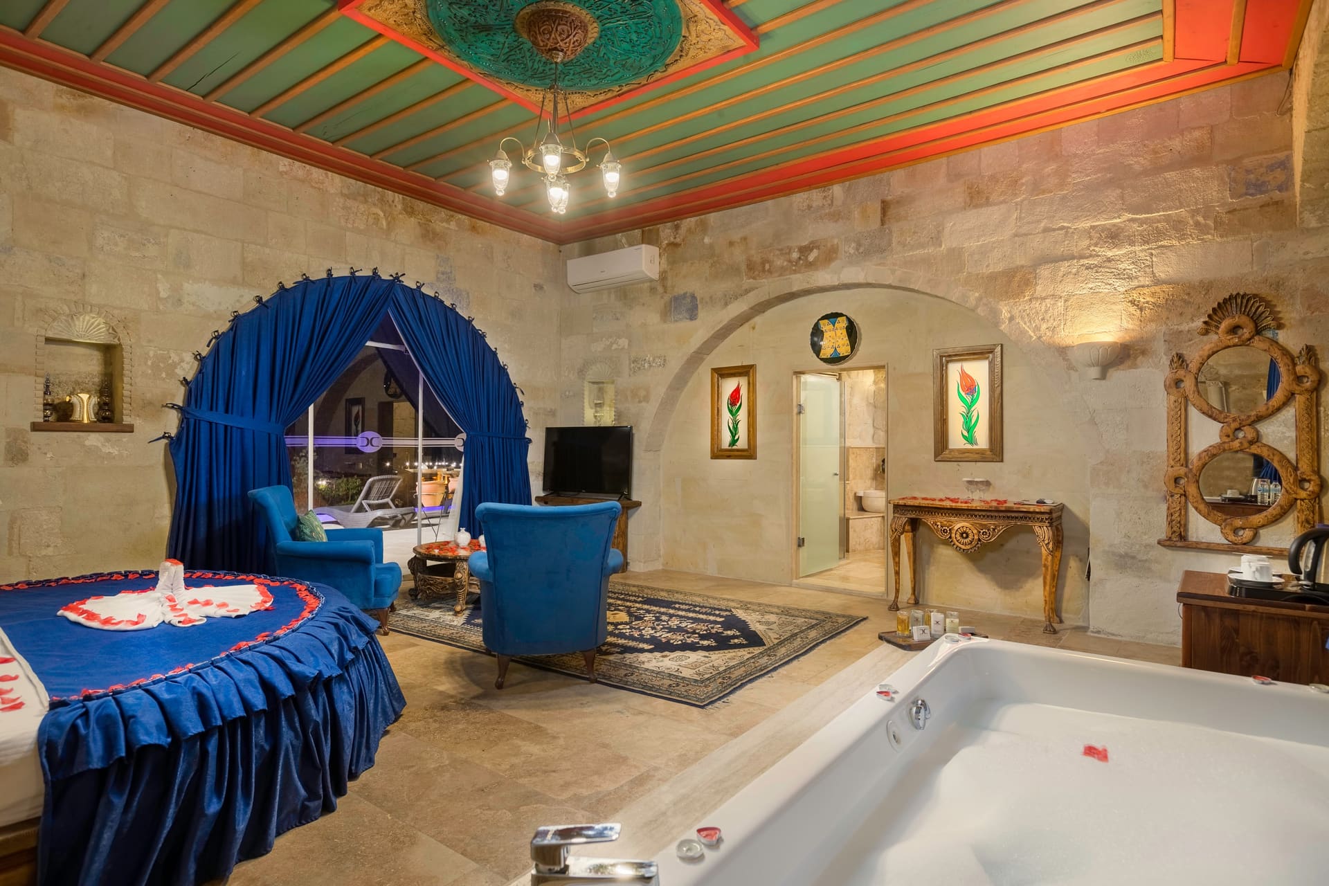 Room 120, Queen Suite: Jacuzzi tub with the round bed behind it, painted ceiling above.