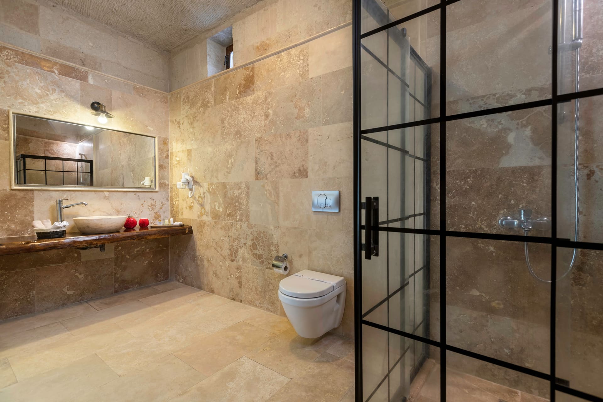 Room 107, King Suite: the bathroom with the sink, toilet and glass shower stall