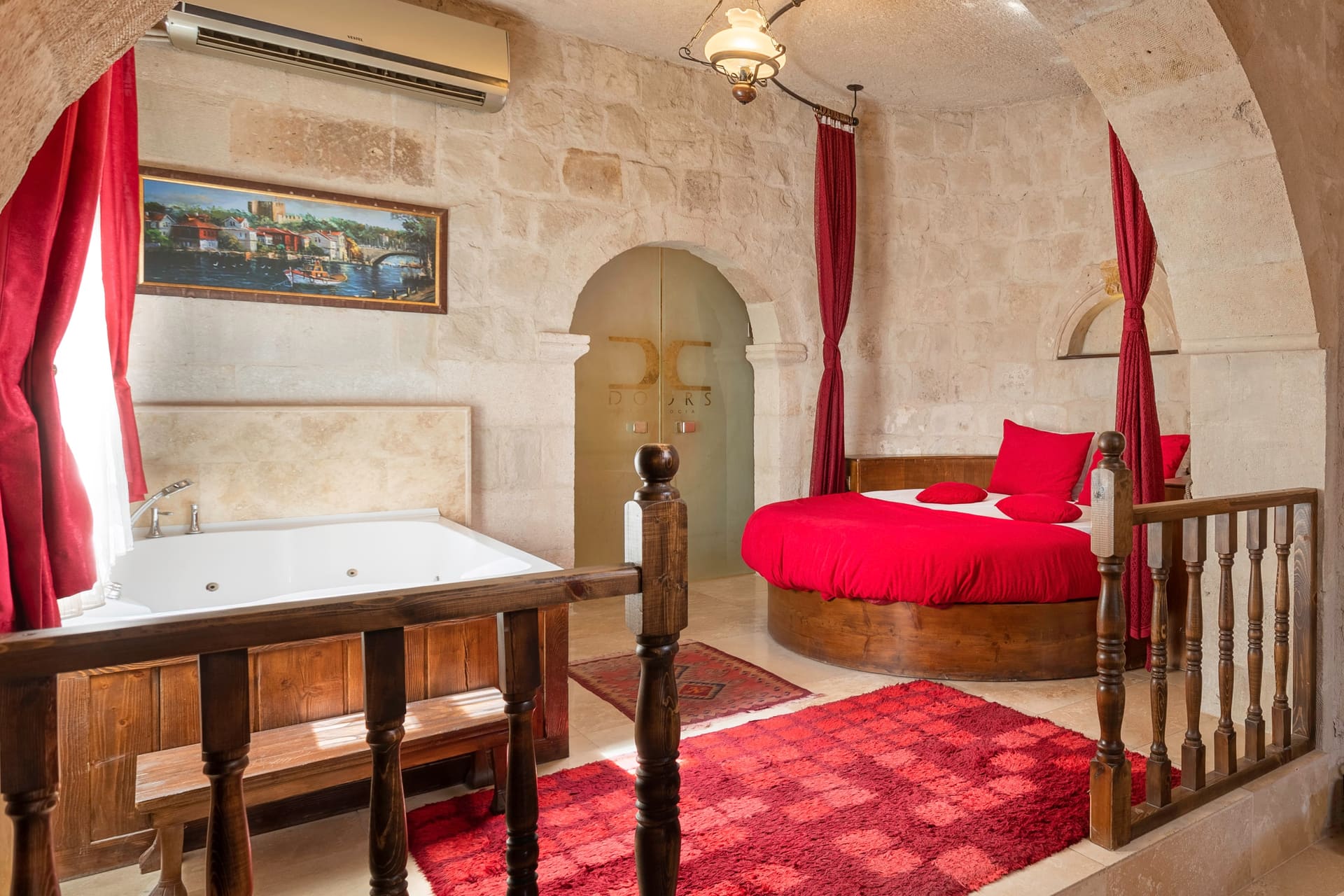 Room 107, King Suite: the jacuzzi tub with the wooden railed steps up to the loft