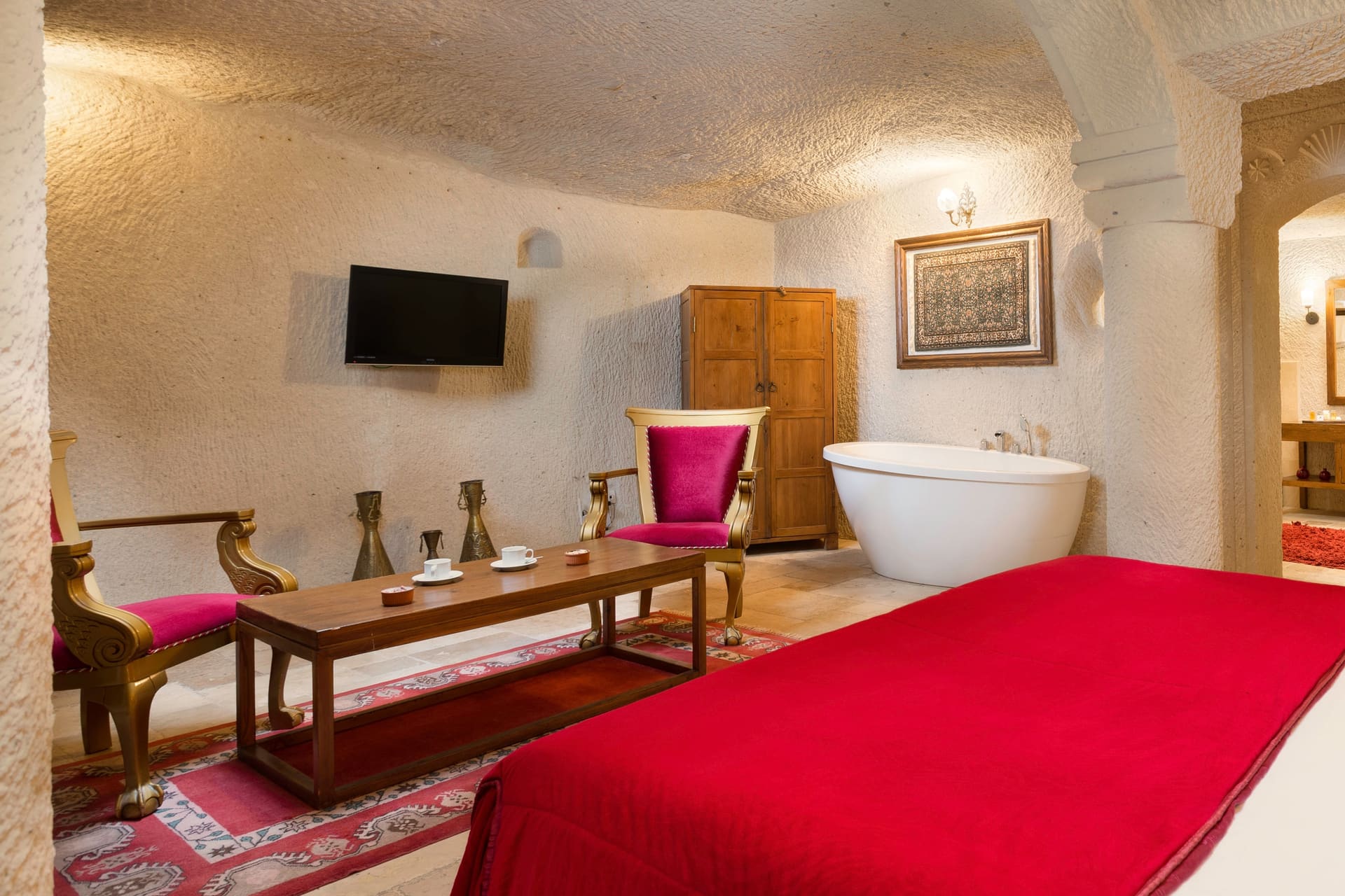 Room 115, Junior Cave Suite: wide room view, wardrobe, bathtub, chairs, wall art above the bed