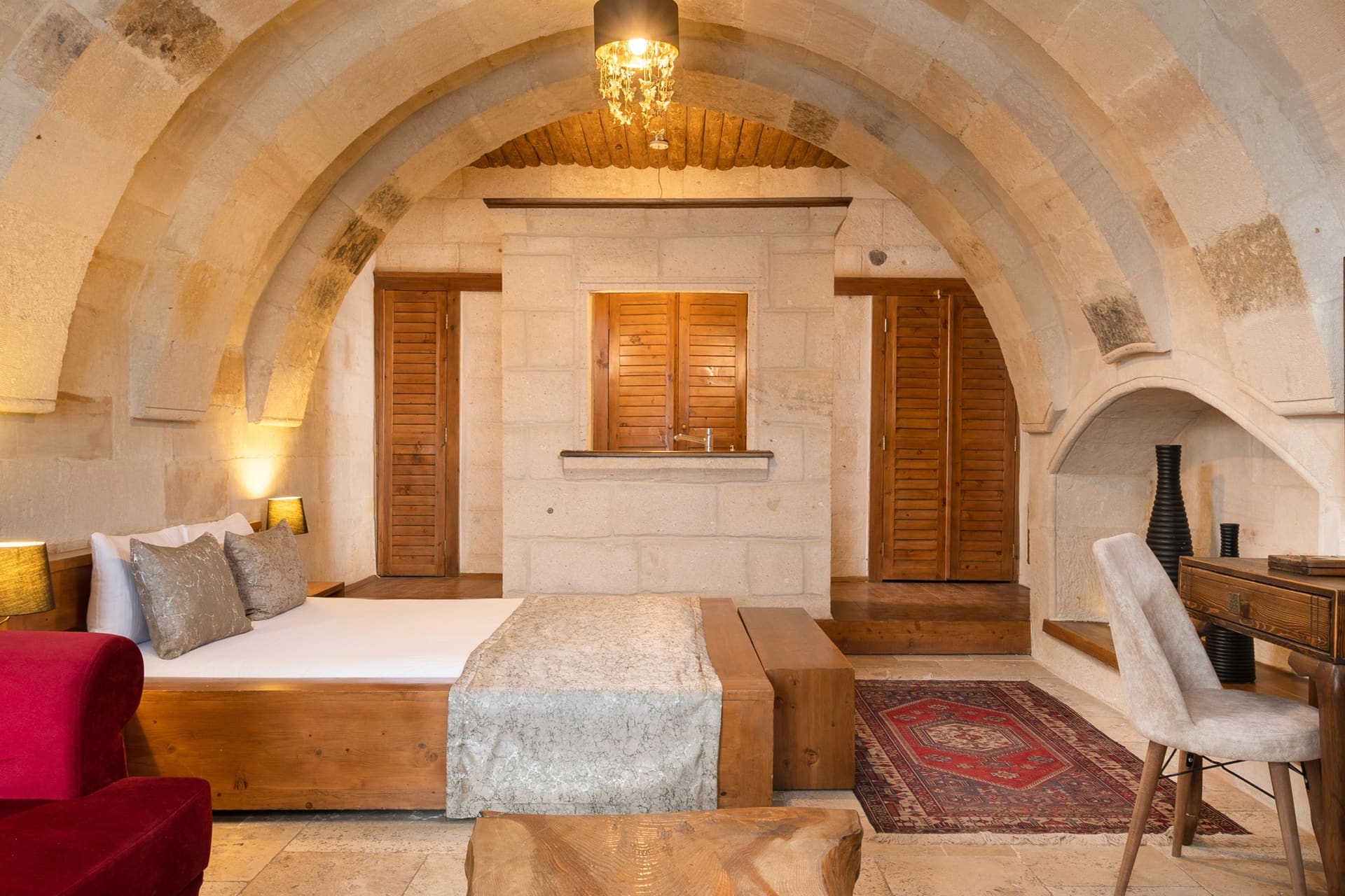 Room 108, Junior Suite: Double bed under the arched ceiling, seen from the side