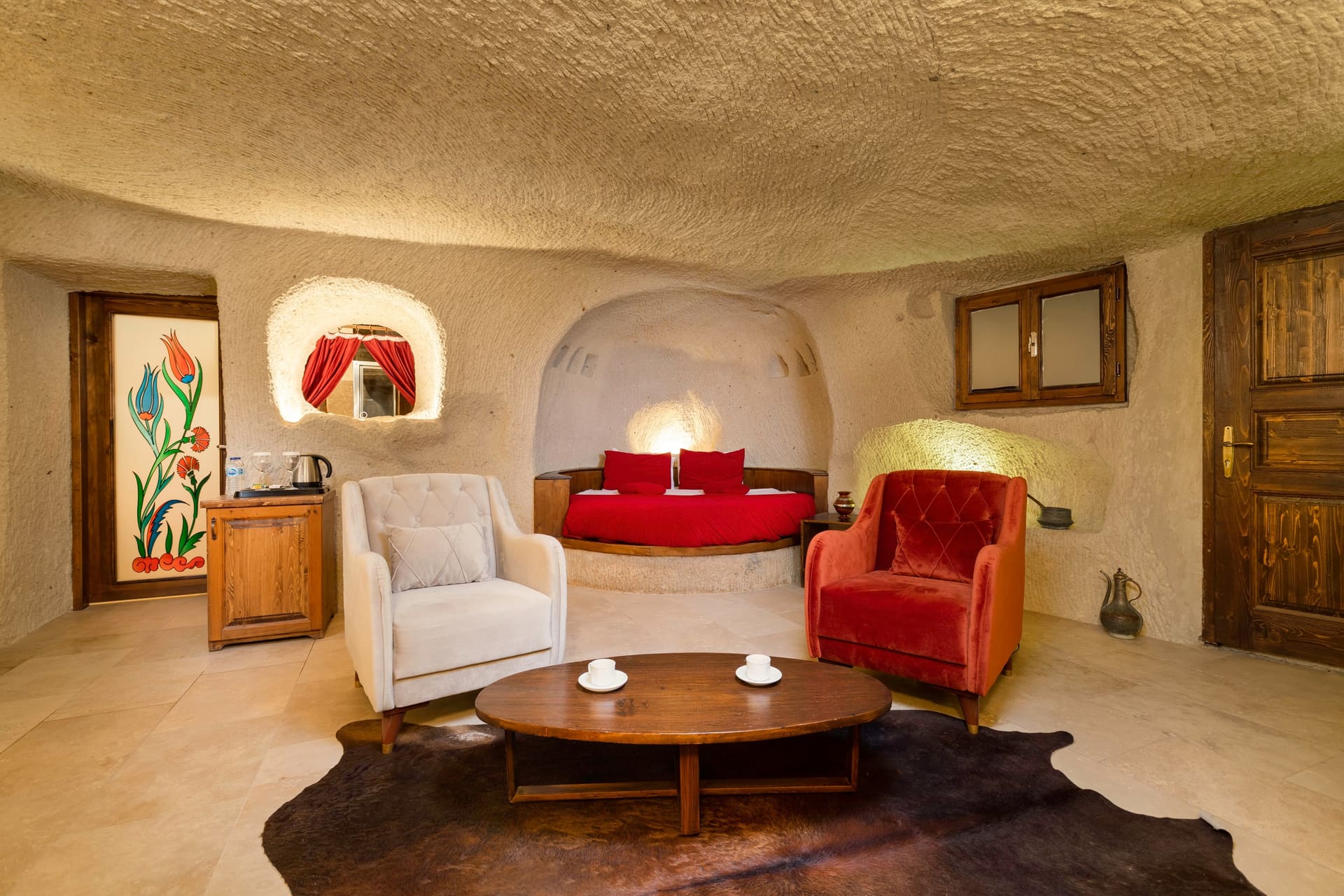 Room 106, King Cave Suite: a wall painting, the bed set in a red-curtained niche, and a wooden cabinet
