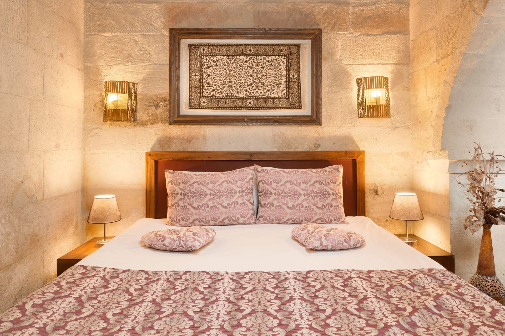 Room 105, King Suite: the headboard shot from an angle that shows the wooden beam ceiling