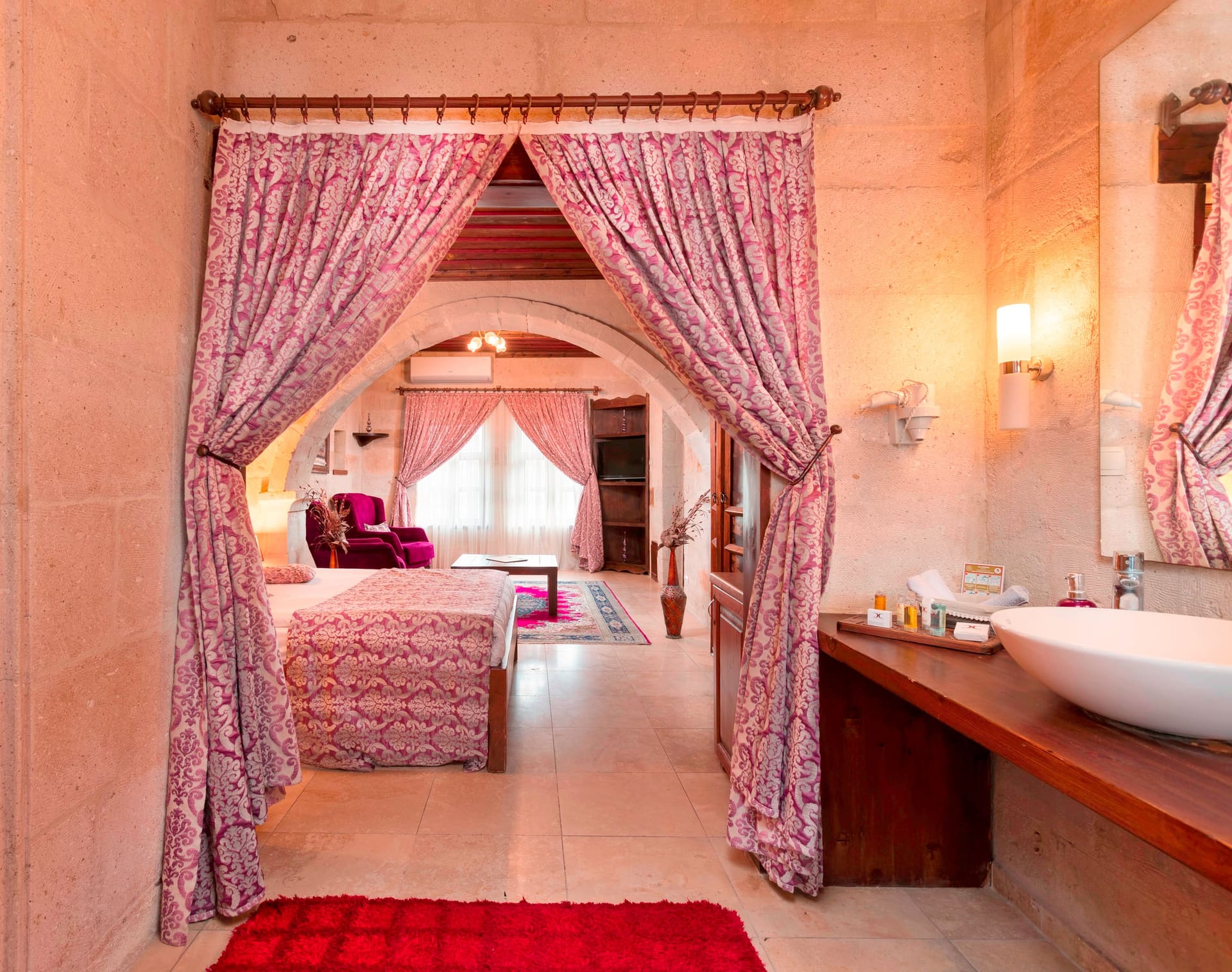 Room 105, King Suite: view from the doorway into the bedroom with a curtain and the sink visible