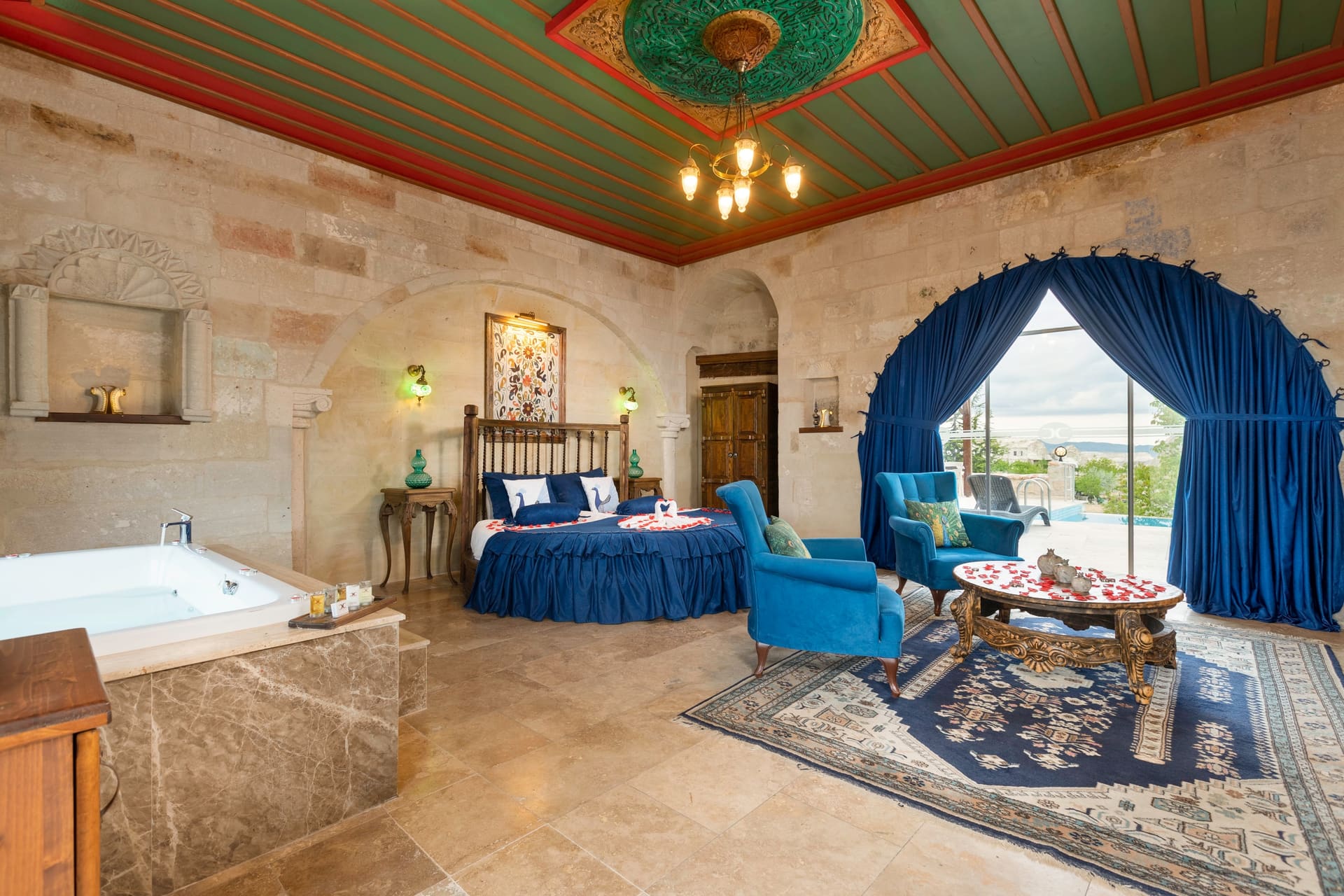 Room 120, Queen Suite: Round bed and jacuzzi tub together in one view, painted ceiling above.