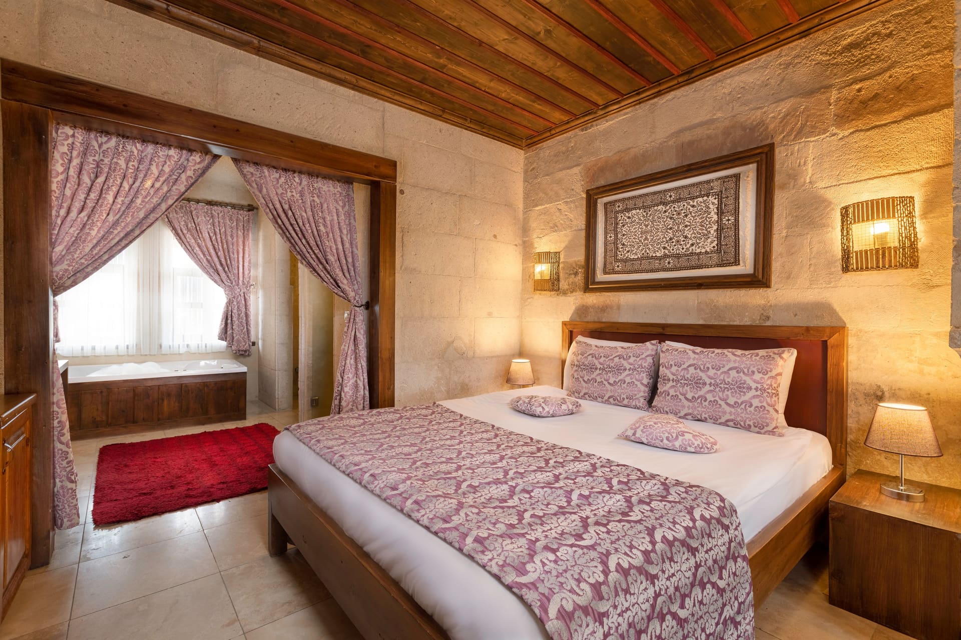 Room 105, King Suite: the bed in front of the open-curtained window with bedside tables