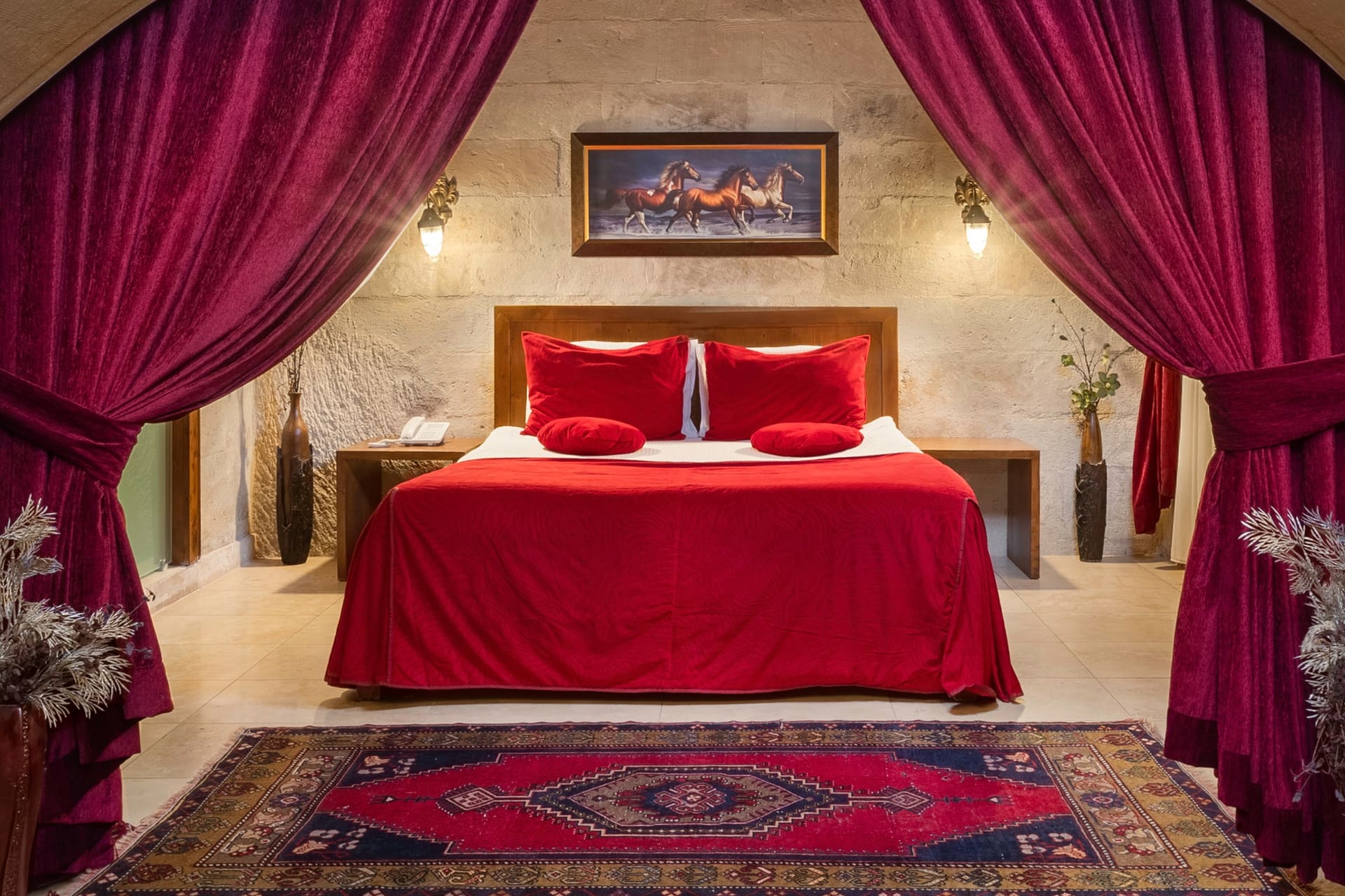 Room 110, Queen Suite: The bed from a different angle, bedside lamps, a patterned rug.
