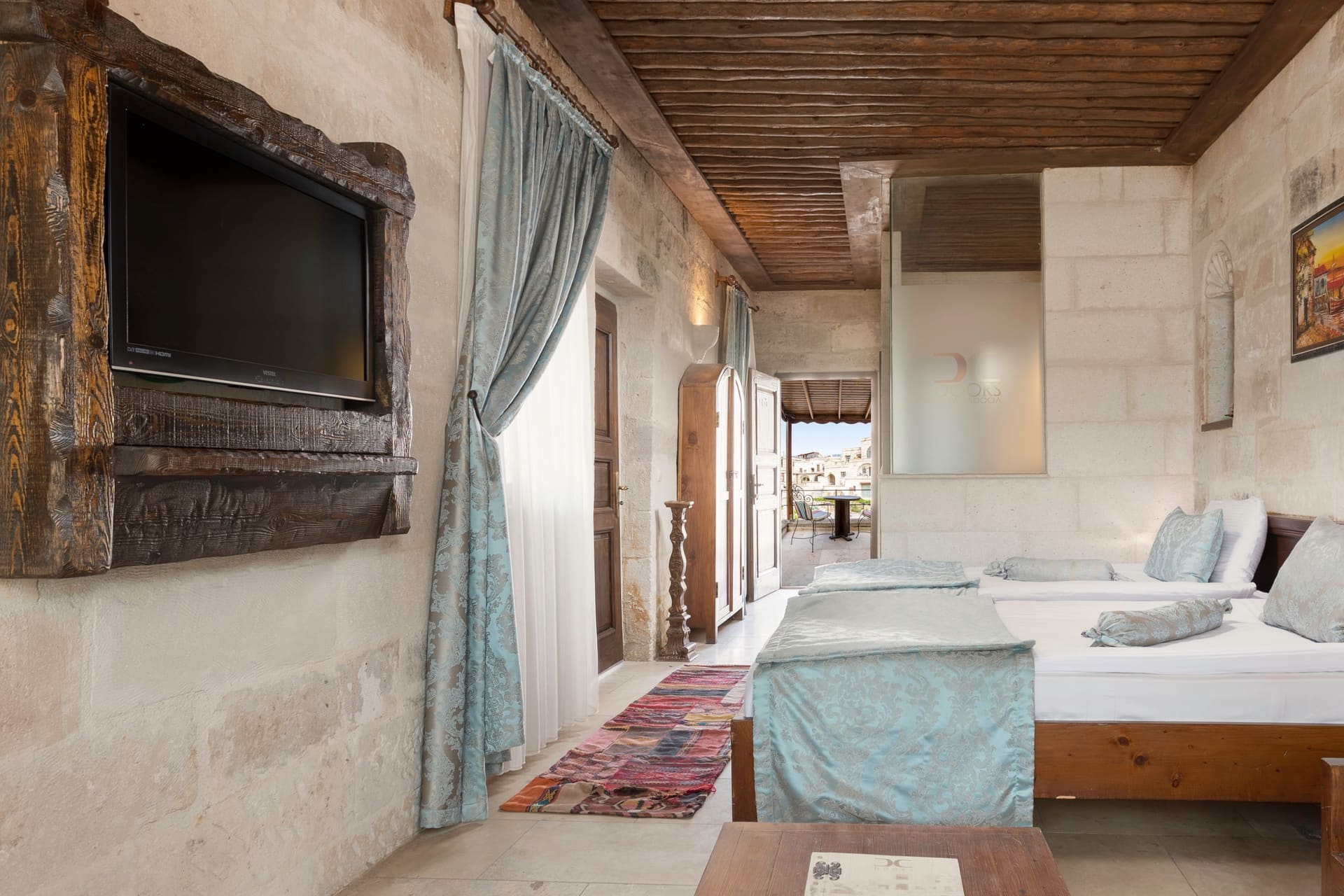 Room 118, Deluxe: Close view of the two beds, wall-mounted television, curtained window